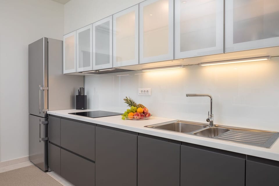 Modern kitchen cabinets, fridge and vitro ceramic stove in the kitchen of the luxury brachfront villa in Sutivan on Brac