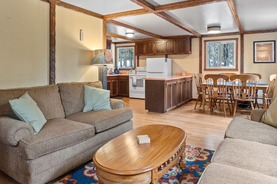 The cozy living room features two sofas, a TV, and a fireplace making it a great spot for a relaxing night in as you warm up by the fireplace.