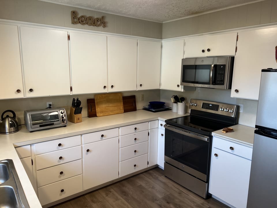 Toaster, microwave, coffee maker, electric kettle, new electric range.