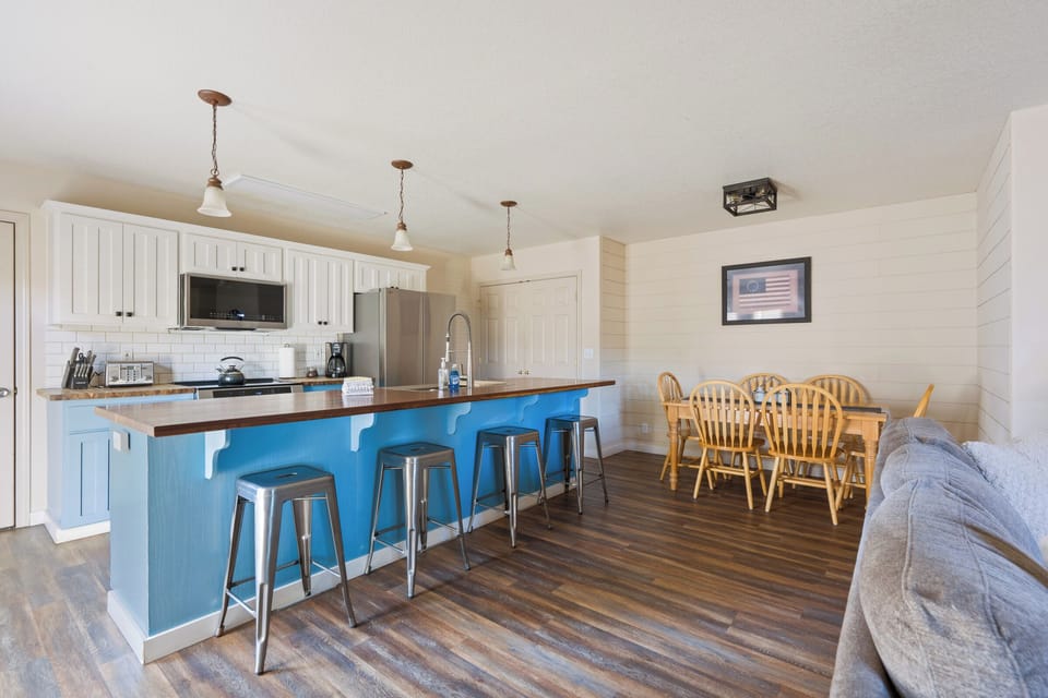 Your spacious open-concept kitchen features a charming blue island perfect for morning coffee and meal prep together.