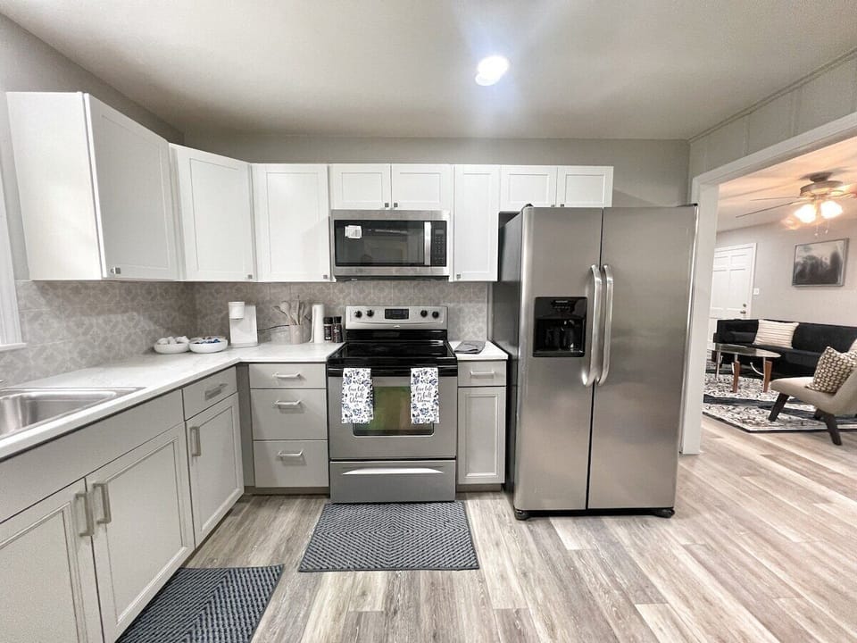 Fully equipped modern kitchen with stainless-steel appliances and sleek finishes.