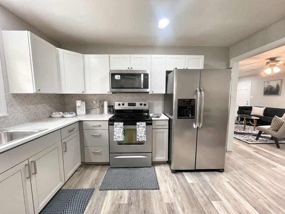Fully equipped modern kitchen with stainless-steel appliances and sleek finishes.