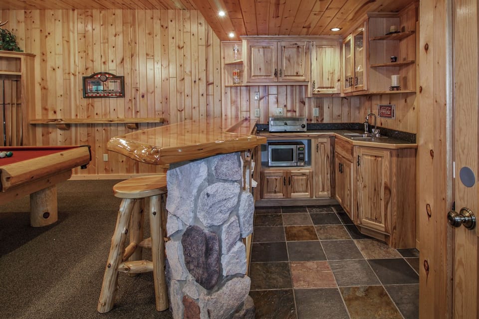 Bar area with sink, refrigerator/freezer, microwave, and pizza oven