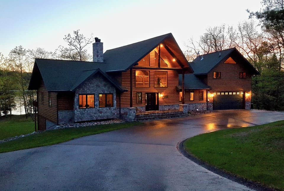Huge covered front porch area with paved circle driveway and plenty of parking