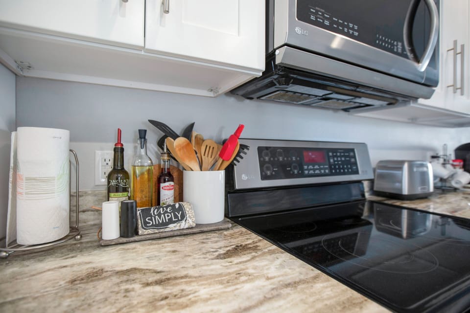 Oil, vinager, salt, pepper and lots of utensils with all cooking essentials. 