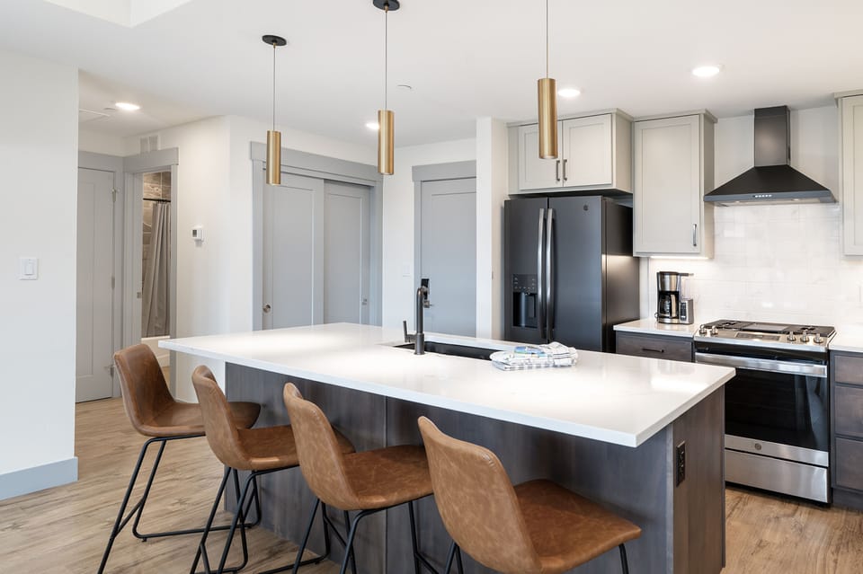 - Modern kitchen with island and bar seating   - Stainless steel appliances and sleek finishes   - Perfect setup for cooking meals during your stay