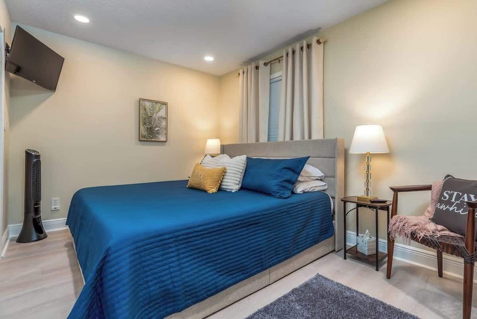 Memory foam King size bed with plenty of pillow options for your comfortable night's sleep. Extra blankets available.  32" Roku TV, standing floor fan for white noise, or extra airflow.  Night stands with USB ports, Bedside lamps for nighttime reading. Blackout shades and additional blinds for light blocking and additional privacy.  Soft rugs on each side of bed.