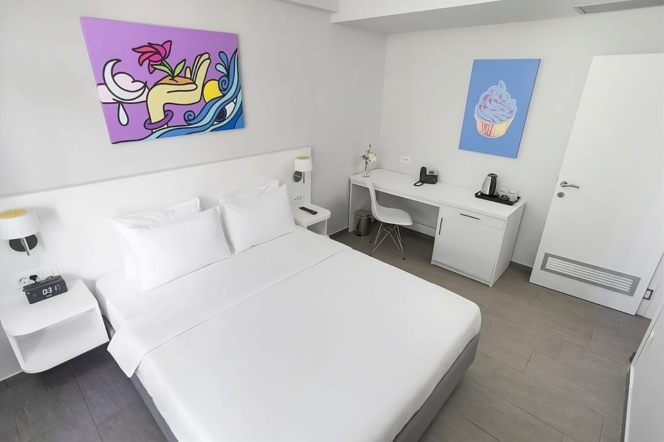 Recharge in a sleek bedroom with artful touches and workspace.