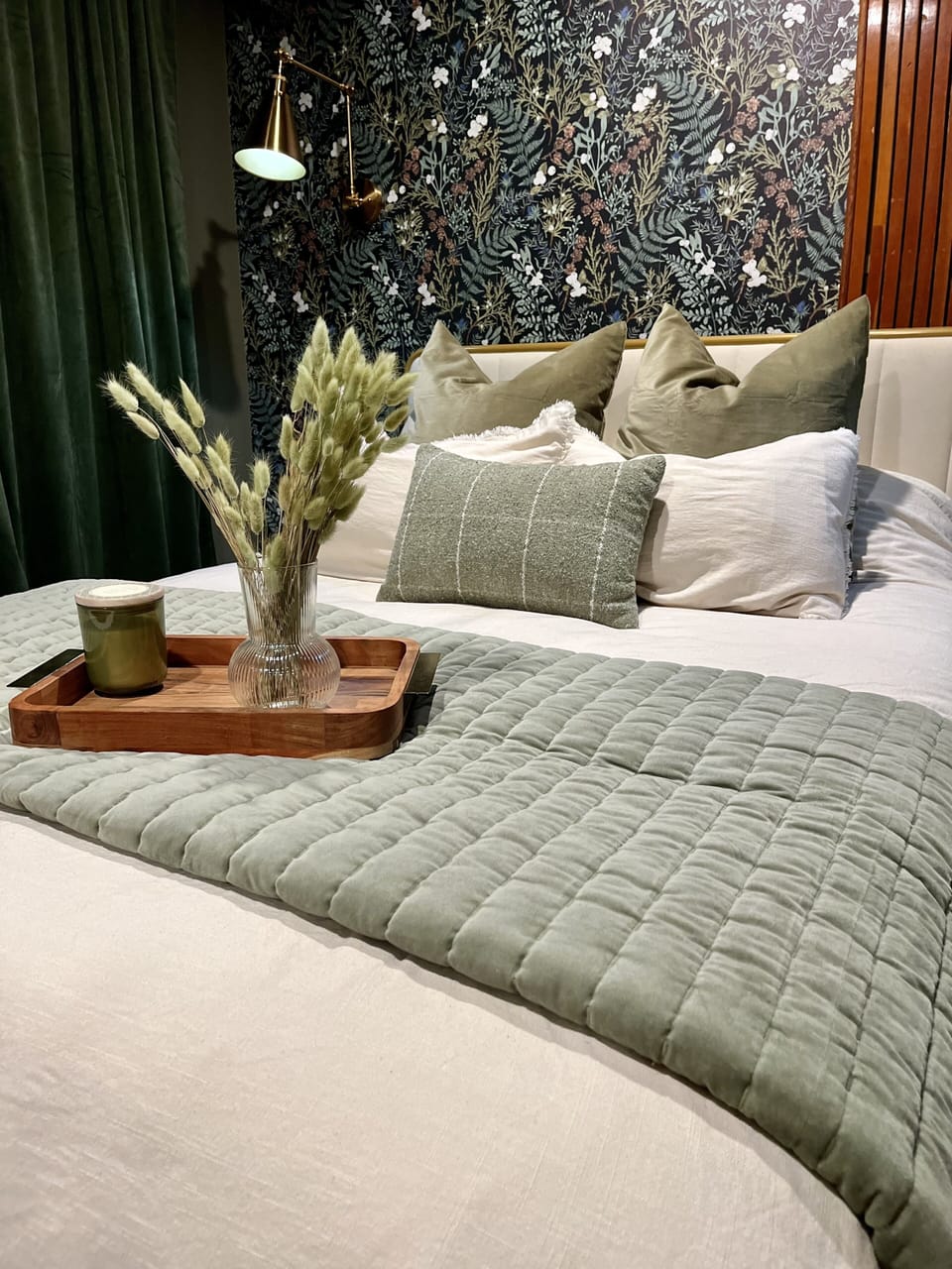 Bedroom with queen size bed overflowing with good down pillows & luxury linens.