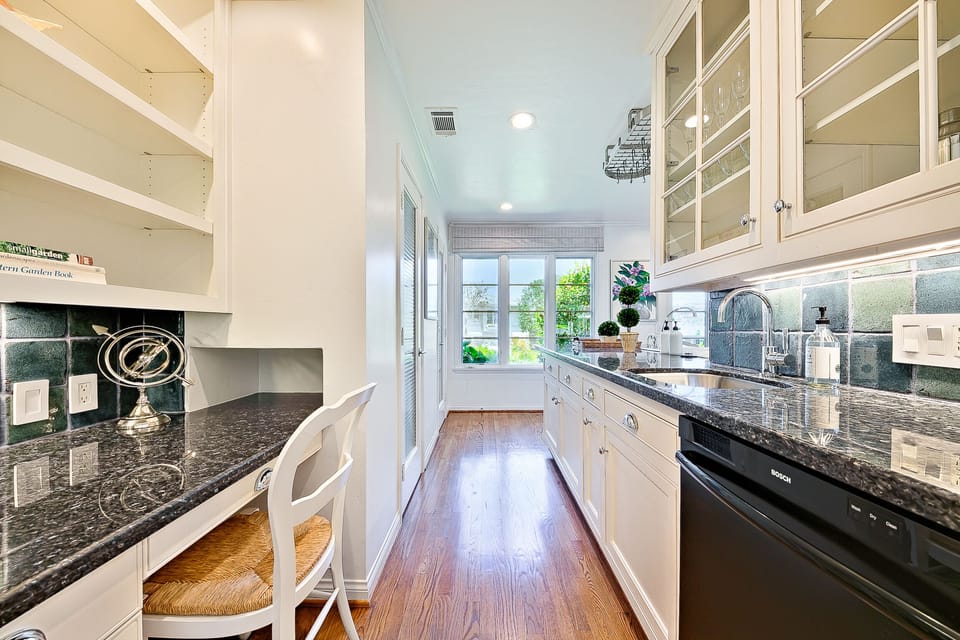 Functional corner with a built-in desk and bar area—perfect for morning coffee or remote work with garden views.