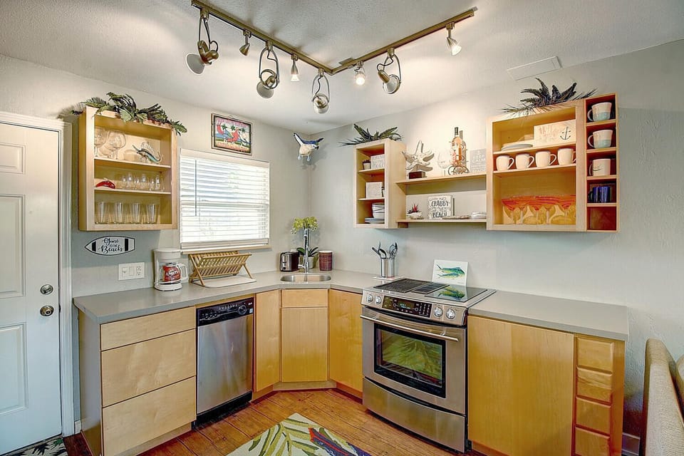Cook your favorite meals in this bright, well-equipped kitchen featuring modern appliances and thoughtful storage throughout your stay.