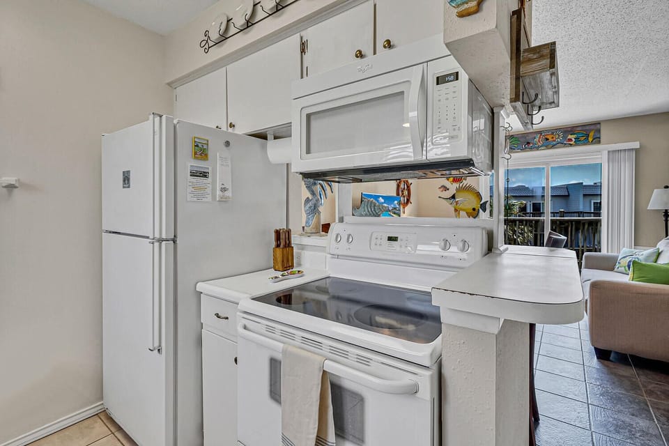 Cook your favorite meals in this fully equipped kitchen with modern appliances and charming coastal accents throughout.
