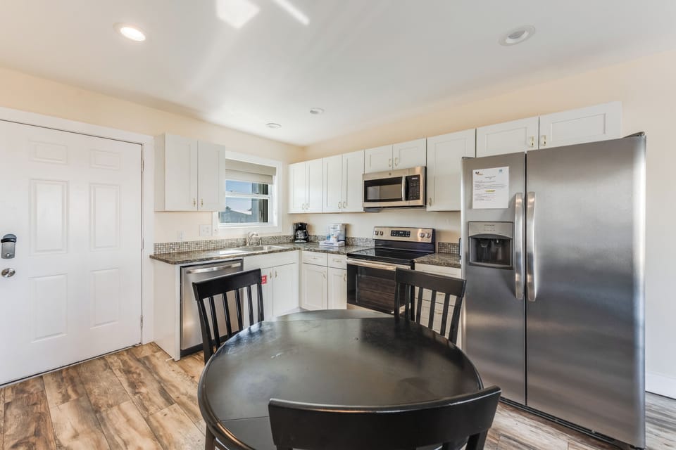 Your fully-equipped kitchen awaits with stainless steel appliances, granite counters, and a cozy dining table for memorable meals together.