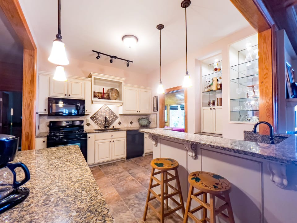 Full kitchen with refrigerator and ice maker on lower level.