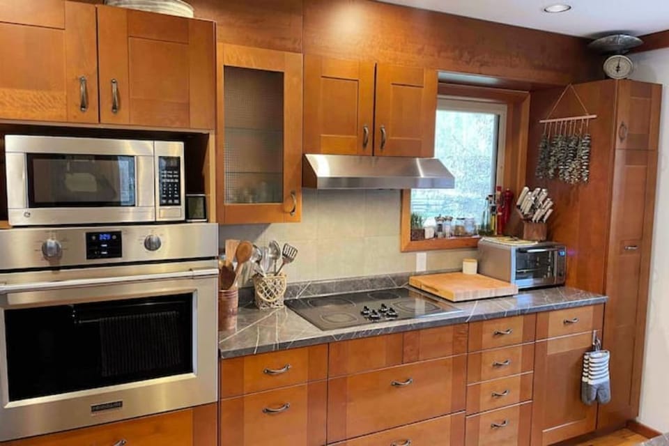Kitchen ready for your culinary expertise, includes convection/microwave ovens.