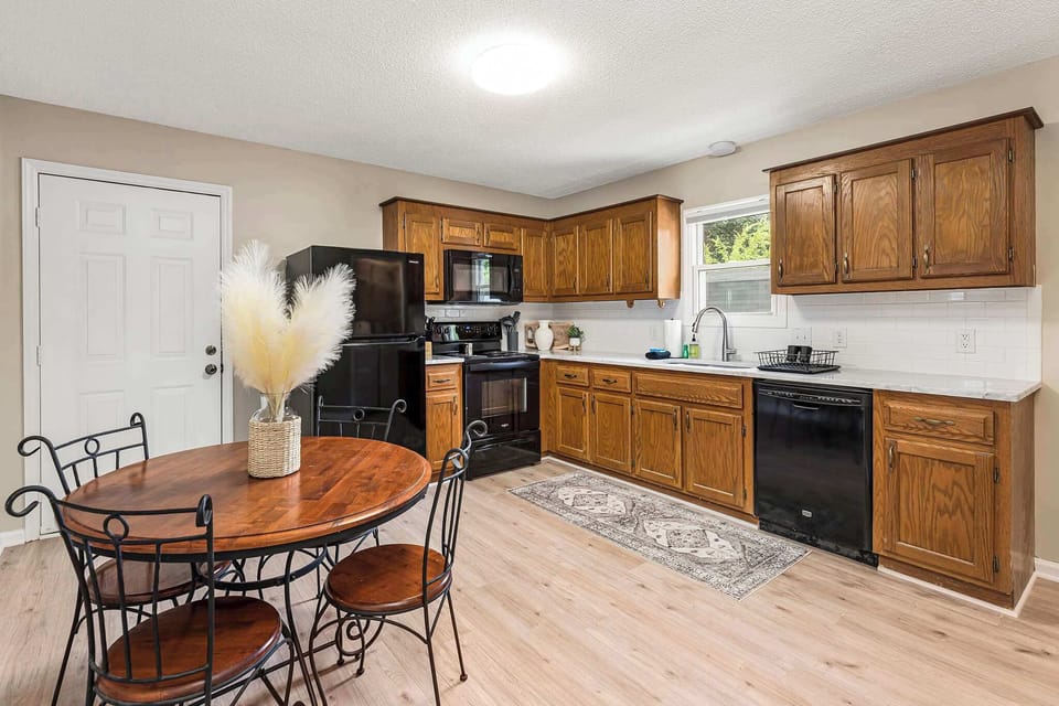 Kitchen featuring fridge, oven, microwave, and dishwasher