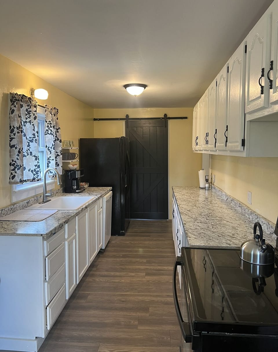 Kitchen with the Downstairs Bathroom door at the end