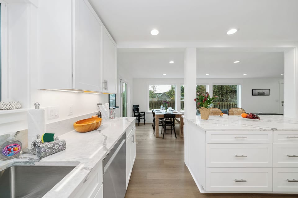 Newly remodeled Kitchen with all new appliances, breakfast bar with 2 stools, Open to kitchen and dining area. With Pass through Window to outdoor living space.
