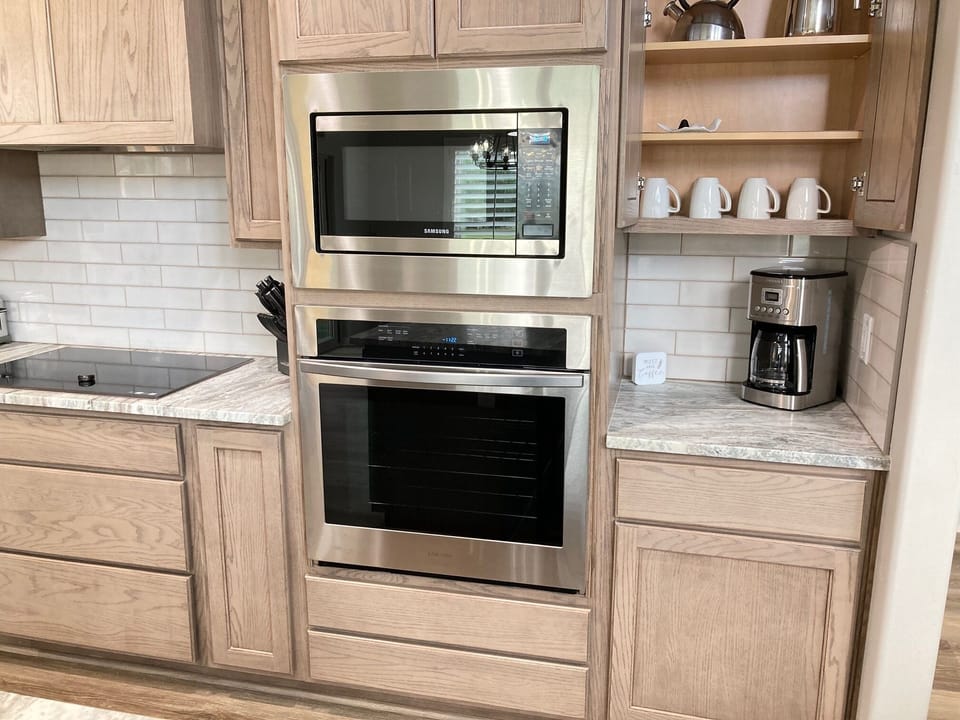 Microwave on top and oven below; coffee bar to the side