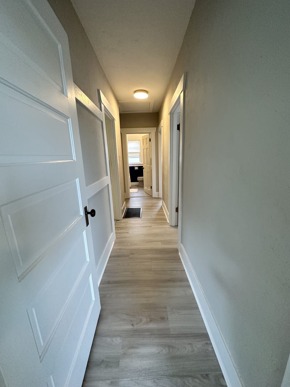 Hallway from front living room & dining area to the bedrooms & bathroom