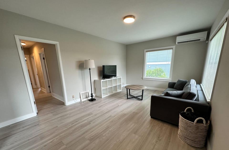 Living room with smart TV and heating/AC unit