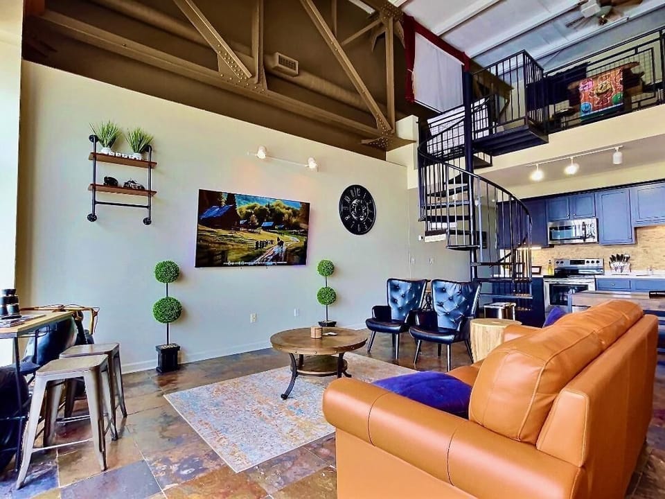 Industrial-Chic Living Space
Relax in a stylish lounge with high ceilings, sleek decor, and a unique motorcycle-inspired table. Cozy seating and natural light make this the perfect spot to unwind after a day of exploring.

