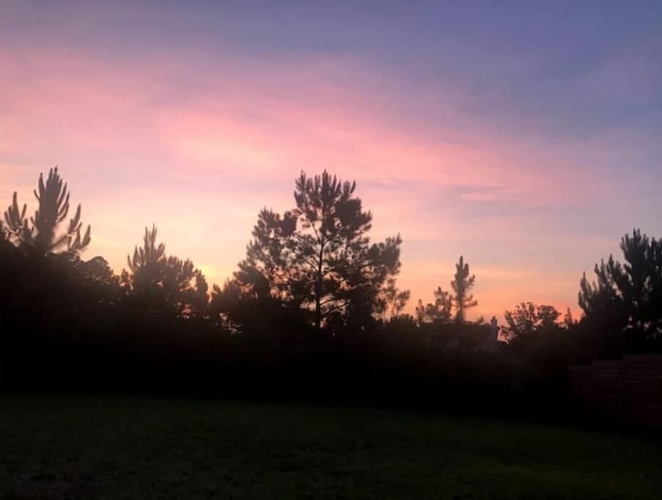 sun set view on 2 person swing in back yard