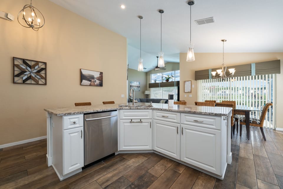 Center island in the kitchen has sink and dishwasher.