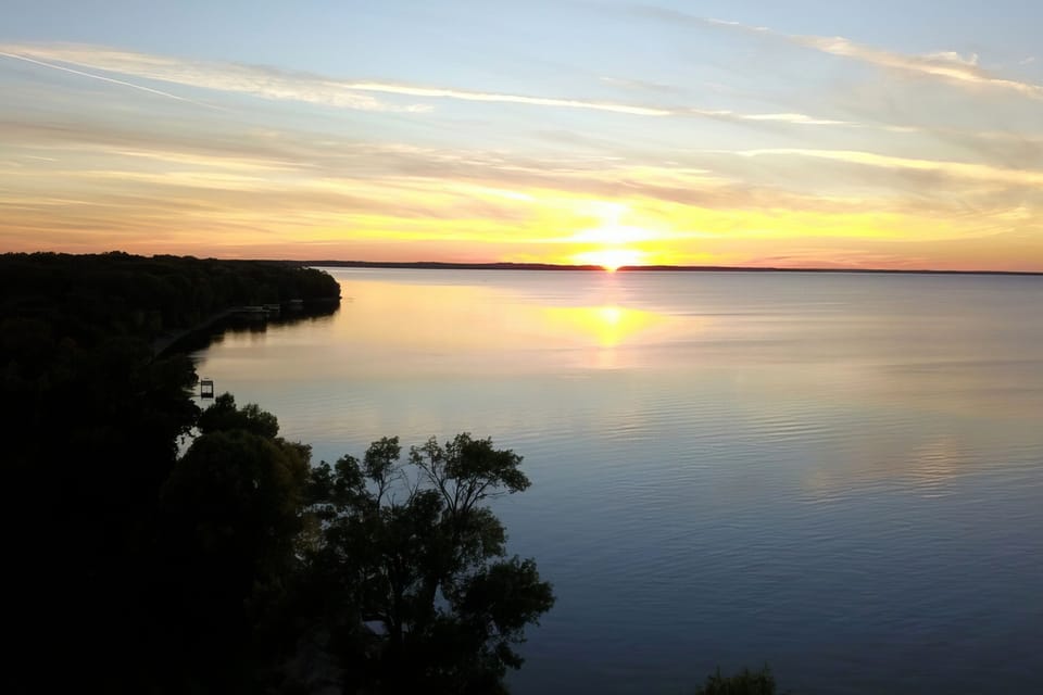 Enjoy beautiful sunsets from our lakeside yard and patios.