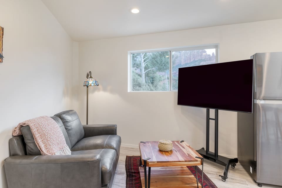 Guest House 1's sitting area features a couch and a TV.