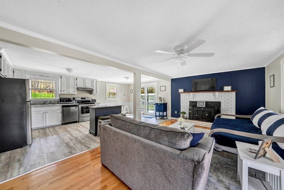 Open living area with cozy seating, fireplace, and seamless flow to the kitchen and outdoor spaces