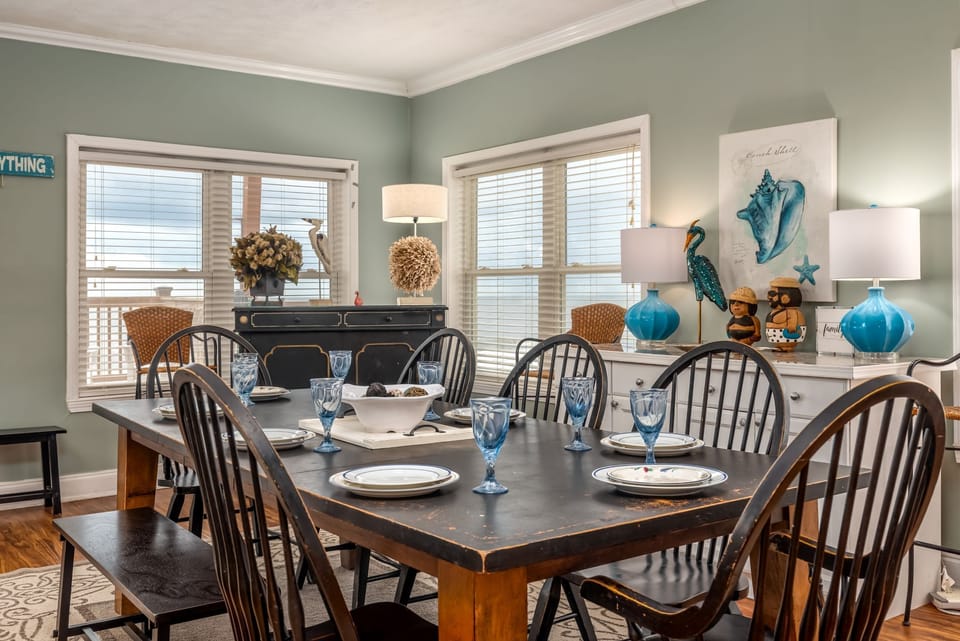 Gather around this elegant dining table where memorable meals and conversations await with coastal charm and natural light.