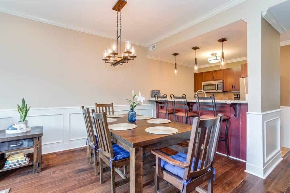 Hardwood harvest table with seating for six guests. Enjoy a delicious meal and set the mood with beautiful lighting.