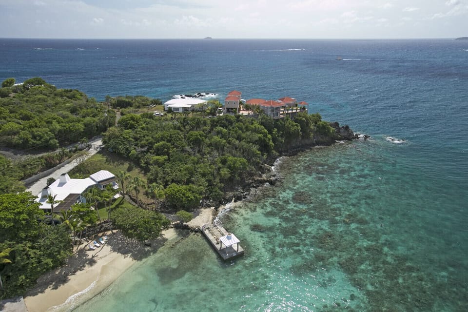 An aerial view of the beach and private dock.