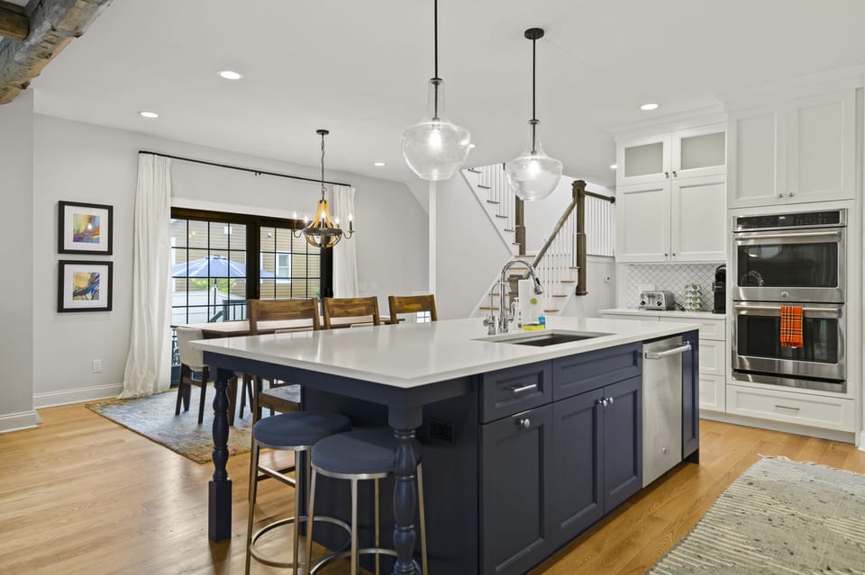 Kitchen with stainless steel appliances, including dishwasher and double oven
