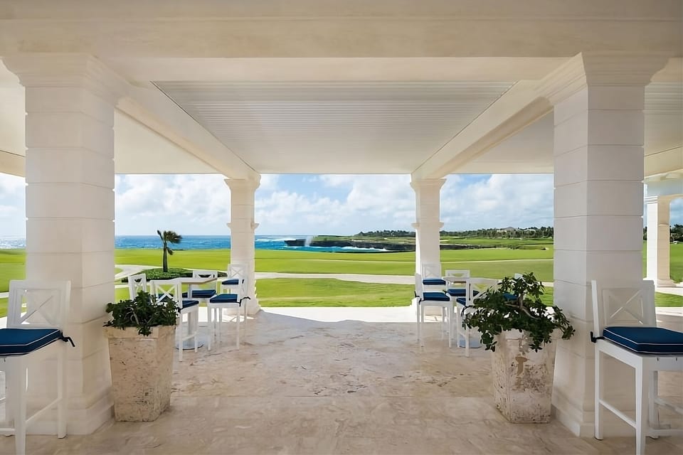 Sip cocktails on the shaded terrace overlooking turquoise waters.