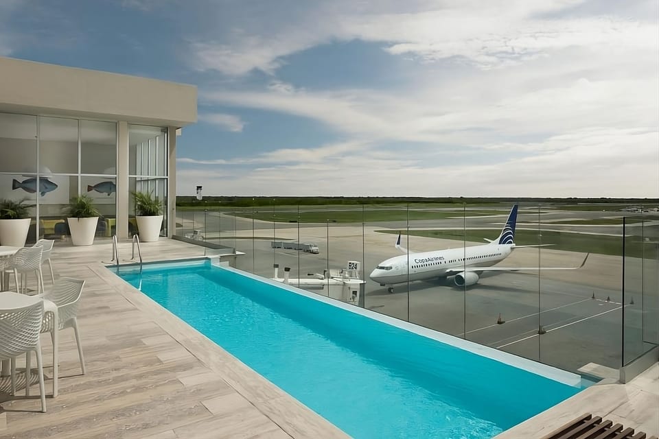 Swim with panoramic views from a sleek rooftop pool deck.
