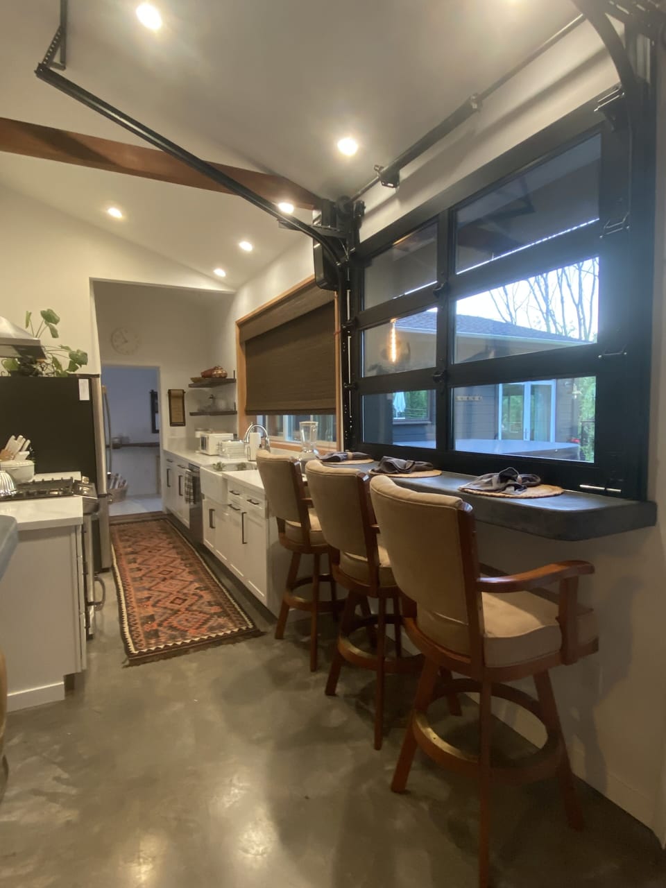 Indoor/outdoor bar with garage door-window to provide a open feeling.  