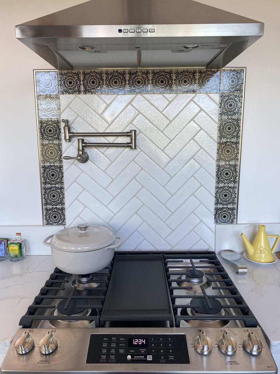 GE gas range w/ griddle, pot filler. Backsplash border tile handmade in Mexico.