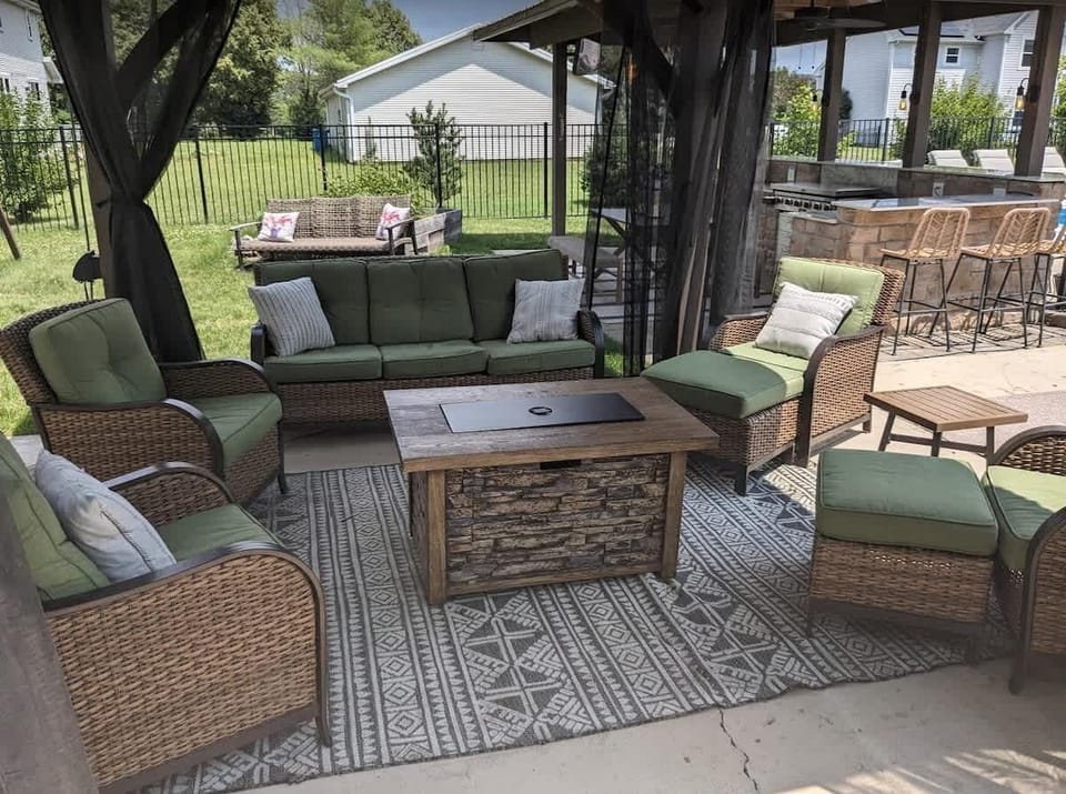 {OUTDOOR SPACE} where warmth and coziness intertwine. Relax and unwind in the comfortable outdoor lounge set nestled under an enchanting gazebo adorned with twinkling lights. With a gentle breeze provided by the fan, you can stay cool while relaxing.