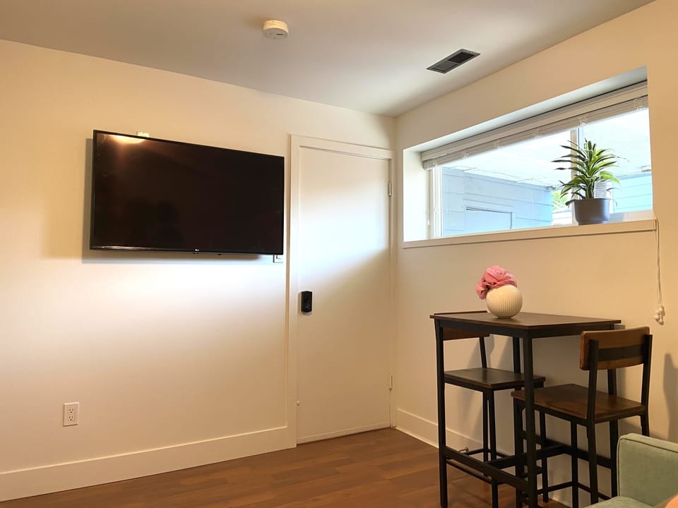 Living room with smart TV and dining table set
