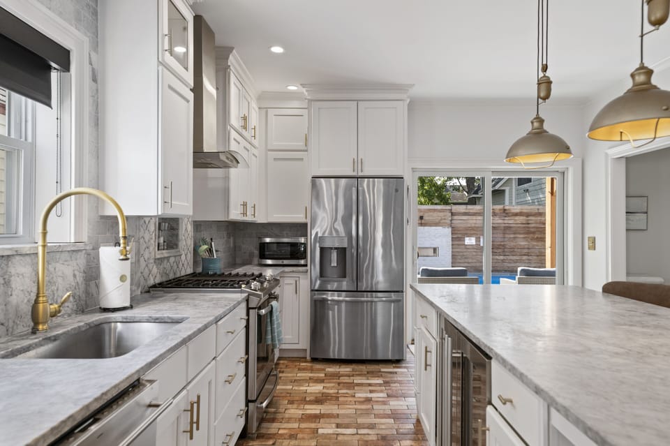Kitchen with stainless steel appliances, dishwasher, and wine fridge