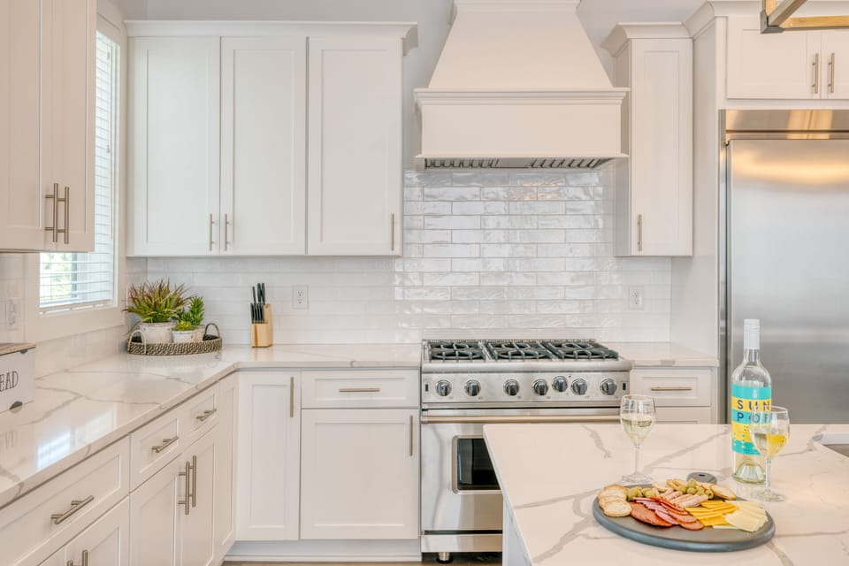 The fully-equipped kitchen features modern appliances, including a gas range.
