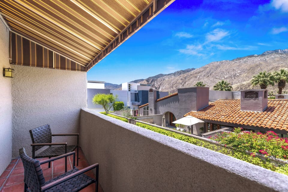 Balcony seating overlooking Palm Springs rooftops and mountain backdrop