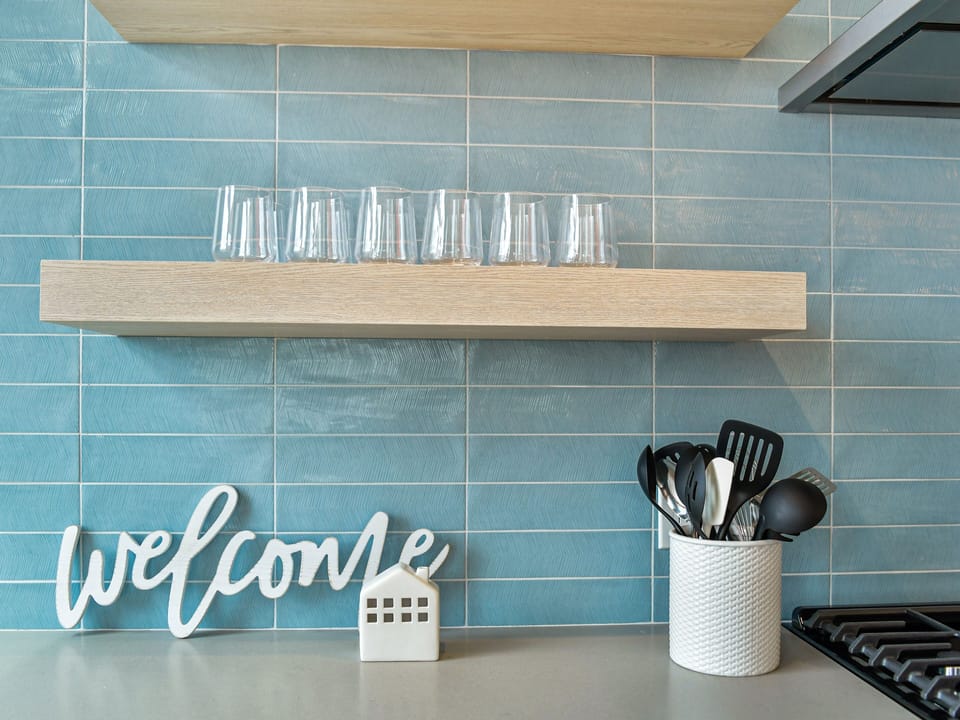 Your stylish kitchen welcomes you with beautiful blue tiles, thoughtful touches, and everything you need to create memorable meals.