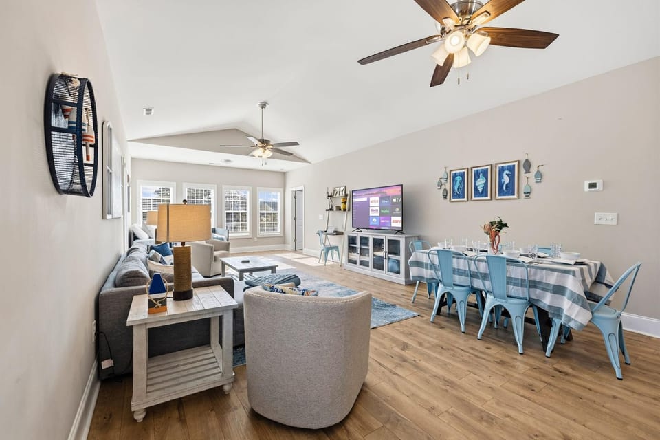 Spacious open living and dining area with coastal charm