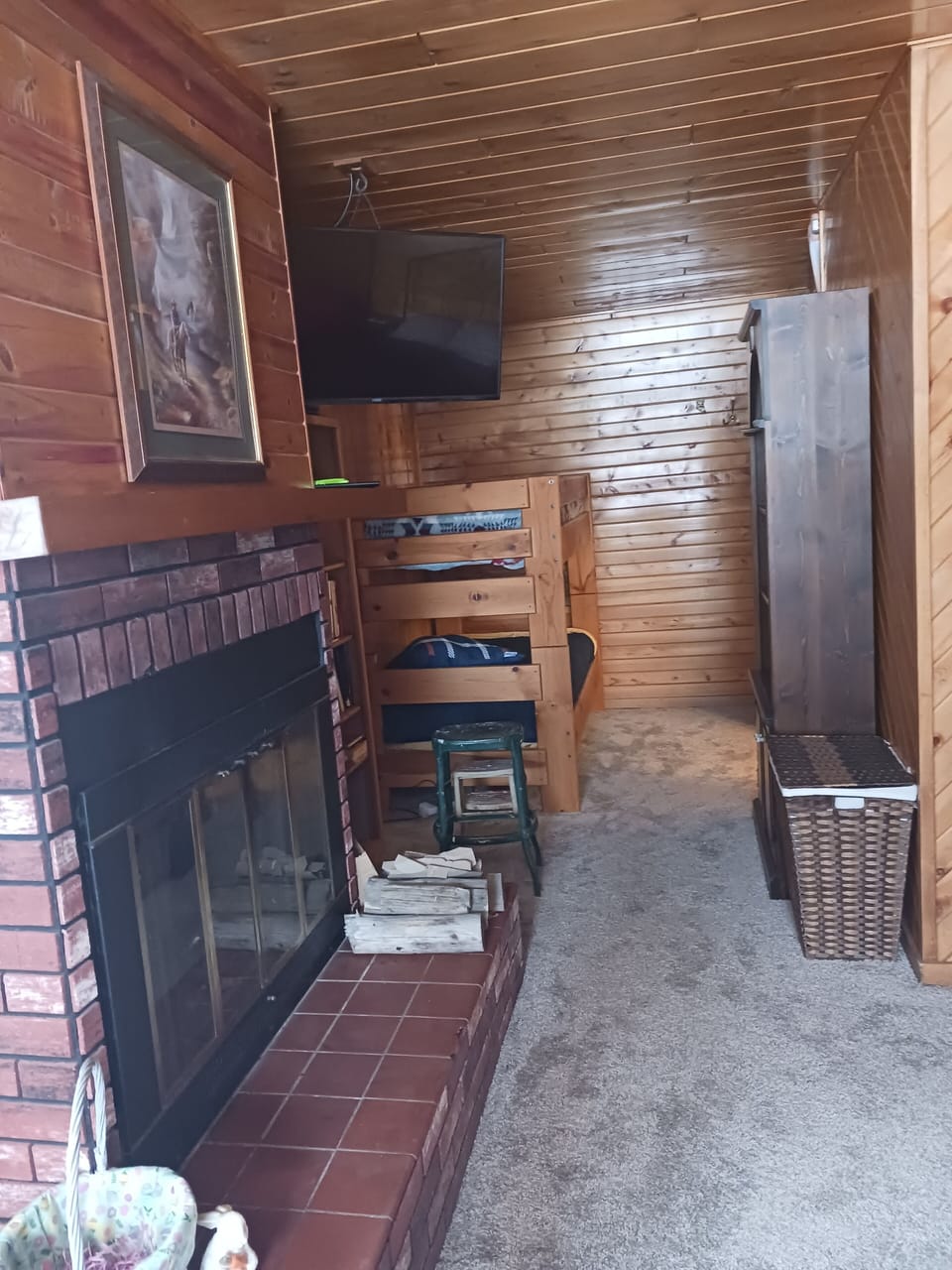The bunkhouse's central fireplace adds mountain charm and warmth.