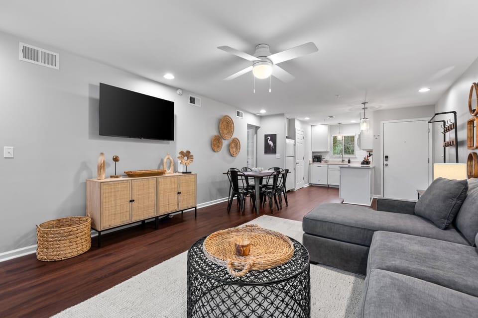 The open floor plan is full of light and has beautiful hardwood floors throughout