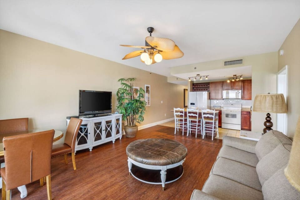 Lakefront Living Area with Sleeper Sofa, Dining Area, Flat Screen TV and Privately Furnished Balcony Access