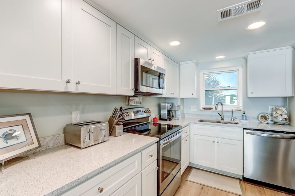Newly Renovated Fully Equipped Kitchen with Stainless Steel Appliances, Quartz Countertops, and Island Seating for 2